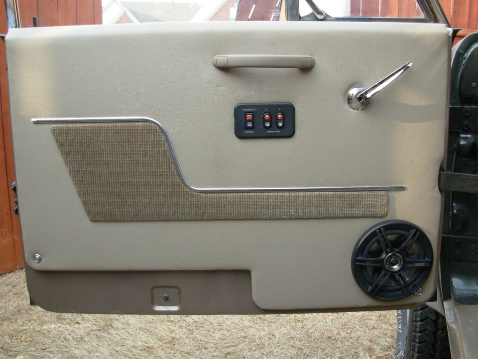 I found a grab handle that we both liked, and it's on.  I think it came from an Expedition.  The inside latch handle & rod came from a Maverick, Pinto, or Mustang II.  The fabric, chrome, & switches came from the '88 F150.  All 4 speakers are Alpine.