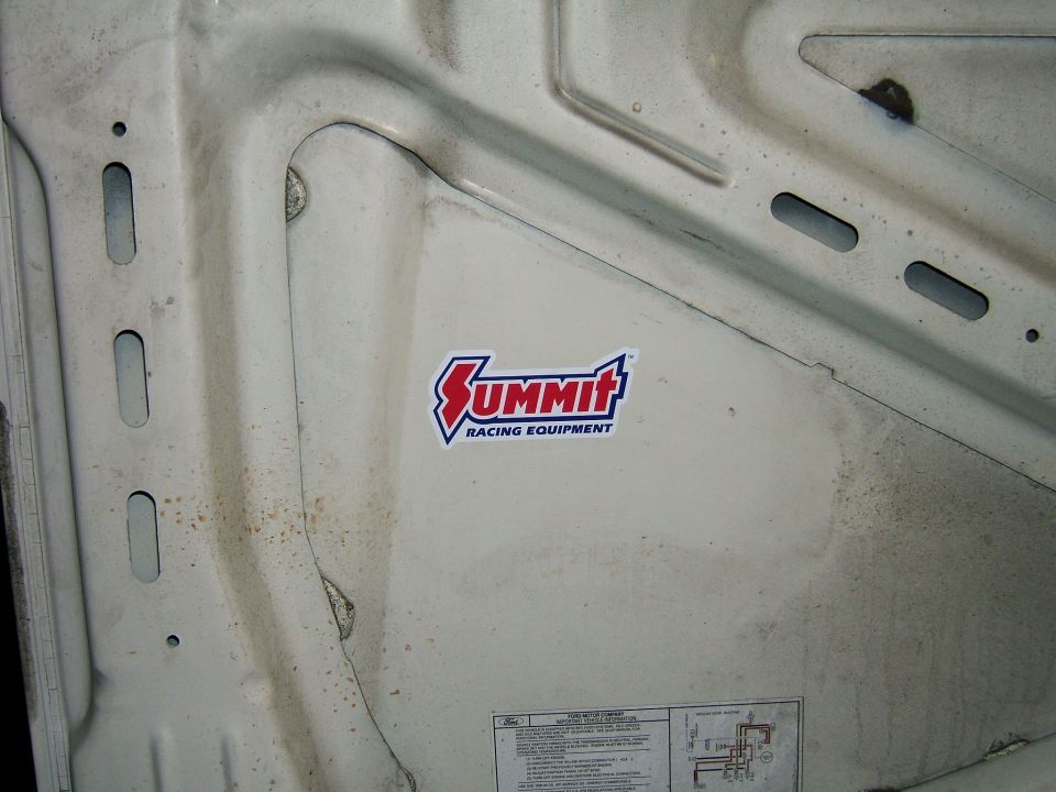 Summit Racing Equipment sticker on the inside of a white hood