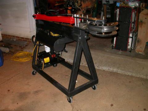 1990 Ford Bronco - Tube bender machine with black frame, red arm, and yellow cord is visible.