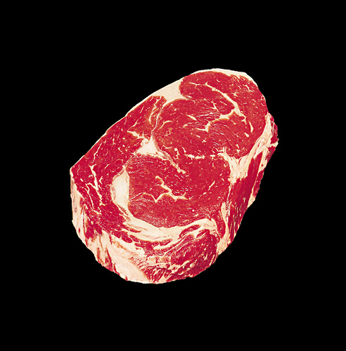 Raw beef steak with marbling on a black background