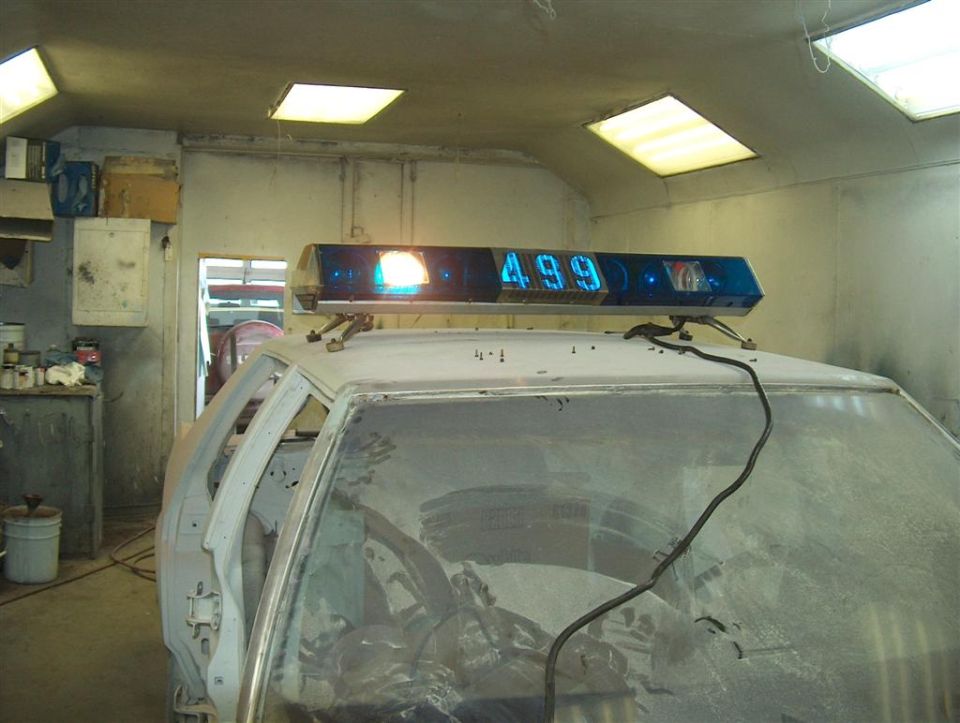 Lightbar with "499" displayed on top of a car interior