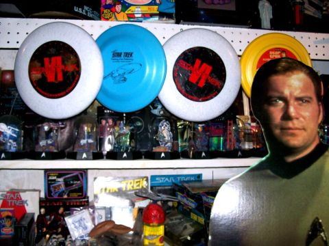 1966 Pontiac Fiero - A collection of Star Trek memorabilia, including frisbees and action figures, is displayed on shelves.