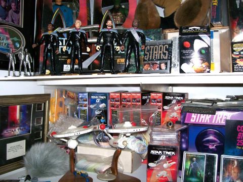1966 Pontiac Fiero - A display of Star Trek merchandise, including figures and model starships, is organized on shelves.