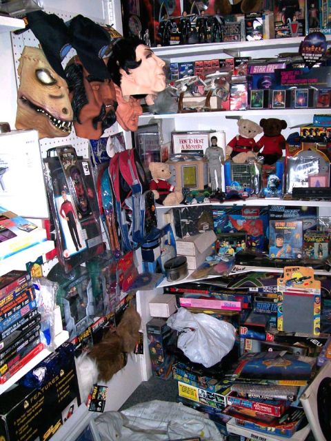 1966 Pontiac Fiero - A collection of Star Trek memorabilia, including masks, action figures, and boxed toys, is displayed on shelves.