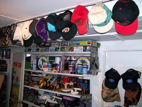 1966 Pontiac Fiero - A collection of Star Trek model kits, toys, and memorabilia is displayed on shelves, with hats hanging above.