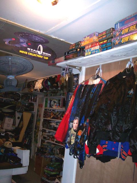 1966 Pontiac Fiero - A room filled with Star Trek merchandise, including puzzles, models, and clothing, with a large Enterprise model suspended from the ceiling.