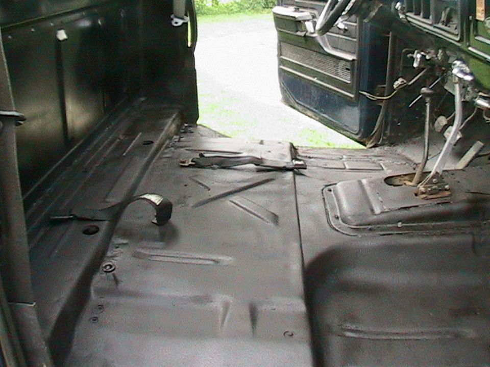 1977 Ford F-250 interior showing floor pan and dashboard area with open door