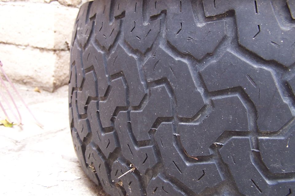 Tire tread with a chevron pattern, close-up view