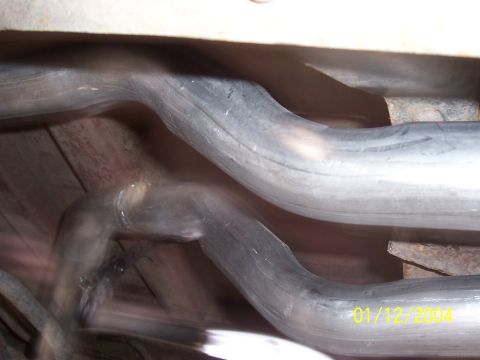 1994 Ford Bronco - The photo shows the underside of a vehicle's exhaust system with two pipes visible.