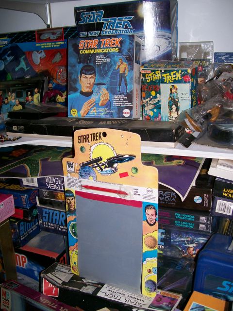 1966 Pontiac Fiero - A collection of Star Trek merchandise is displayed on shelves, various toys and memorabilia.