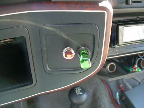 1988 Ford Bronco - Interior view of a vehicle dashboard with aftermarket switches and a gear shifter.