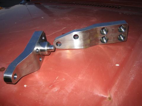 1987 Suzuki Samurai - Custom metal suspension components are displayed on a red surface, likely a vehicle hood.