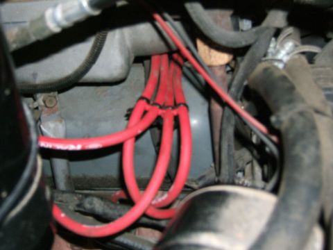 1991 Ford Bronco - Red spark plug wires are visible in the engine bay, bundled together.