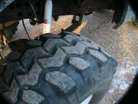 1977 Ford F-250 - The image shows the underside of a truck, focusing on the tire and suspension system.