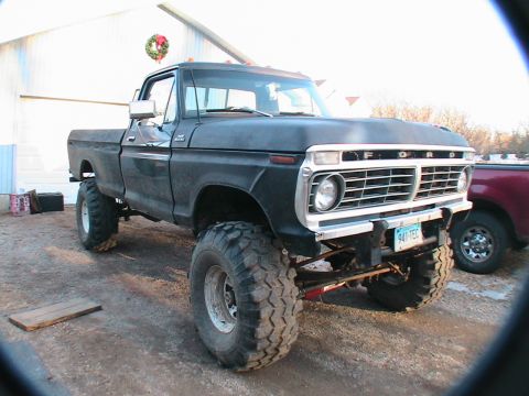 1977 Ford F-250 - This lifted 1977 Ford F-250 pickup truck features large off-road tires and a prominent grille.