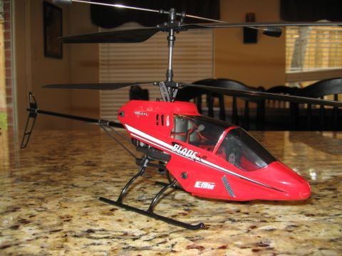 1986 Ford Bronco - A red remote control helicopter, identified as a Blade model, is displayed on a speckled countertop.