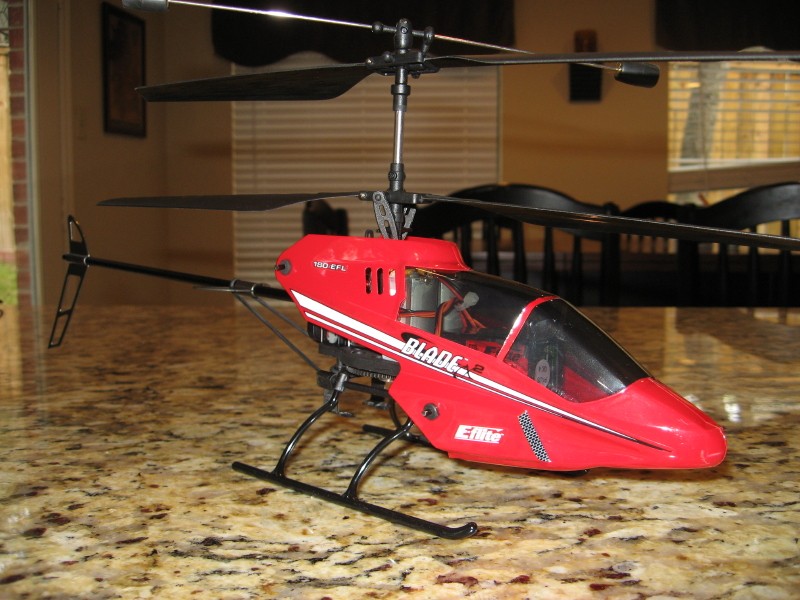Red remote control helicopter with 'BLADE' logo