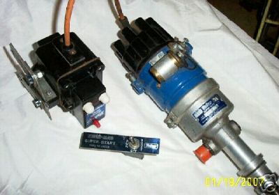 1972 Ford Ranchero - Two automotive ignition components, a coil and a distributor, are laid out with a switch.