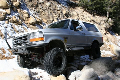 1996 Ford Bronco - This 1996 Ford Bronco navigates a rocky, snow-dusted mountain path.