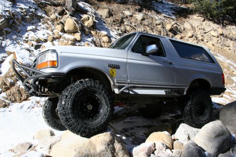 1996 Ford Bronco - This 1996 Ford Bronco, equipped with a heavy-duty bumper and aggressive tires, tackles a challenging off-road course in snowy terrain.
