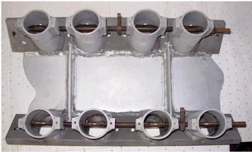Close-up of an eight-barrel intake manifold with four barrels on top and four on the bottom