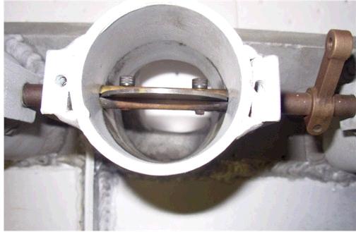 Throttle body with butterfly valve and linkage, white housing, metal components
