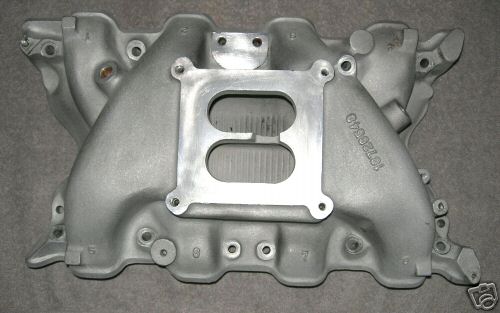 Aluminum intake manifold with a central square opening and two rectangular openings