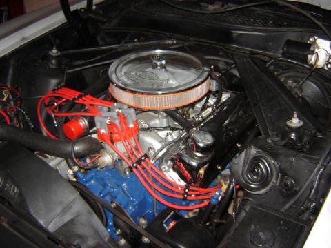 1972 Ford Ranchero - Close-up of a V8 engine bay, likely from a 1972 Ford, a chrome air cleaner and red ignition wires.