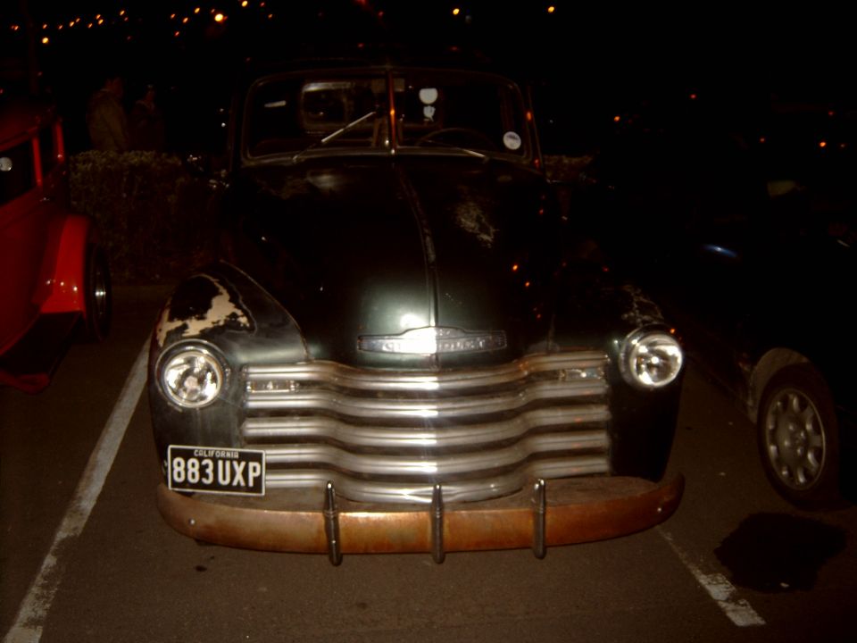 Dark green vintage Chevrolet pickup front view at night