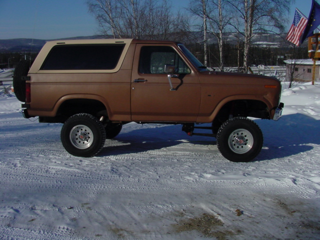 Brown 1986 Ford Bronco side view with spare tire on rear