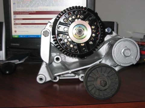1991 Ford Bronco - Close-up of an automotive alternator, a component of the engine's electrical system.