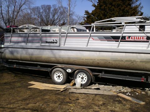 1983 Ford Bronco - Sunbird pontoon boat on a trailer, with Lowe branding visible on the side.