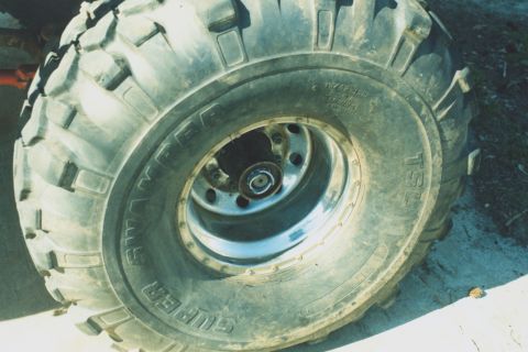 1978 Ford Bronco - A close-up view of a Super Swamper tire and chrome wheel, likely for an off-road vehicle.