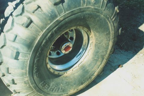 1978 Ford Bronco - Close-up of a Super Swamper tire and wheel assembly, likely from an off-road vehicle.