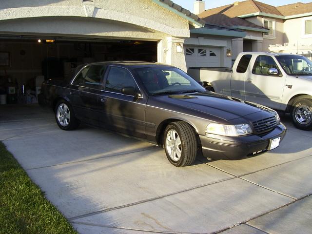Gray Ford Crown Victoria sedan parked in a driveway