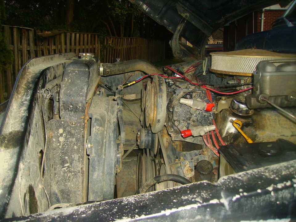 Engine bay with radiator, fan, and engine components visible