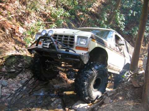 1992 Ford Mustang - A modified 1978 Ford Bronco tackles a challenging off-road course with large tires and a winch.