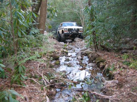 1992 Ford Mustang - This 1978 Ford Bronco navigates a challenging off-road path through a wooded stream.