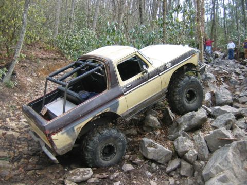 1992 Ford Mustang - Modified pickup truck navigates a challenging rocky trail.