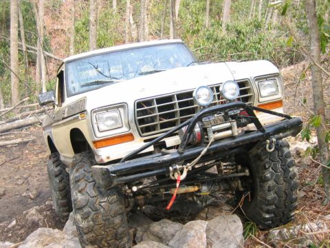 1992 Ford Mustang - This modified 1979 Ford F-150 truck navigates a rocky, wooded trail with its front end angled upwards.