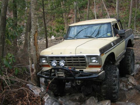 1992 Ford Mustang - This modified pickup truck navigates a challenging rocky trail, its off-road capabilities.