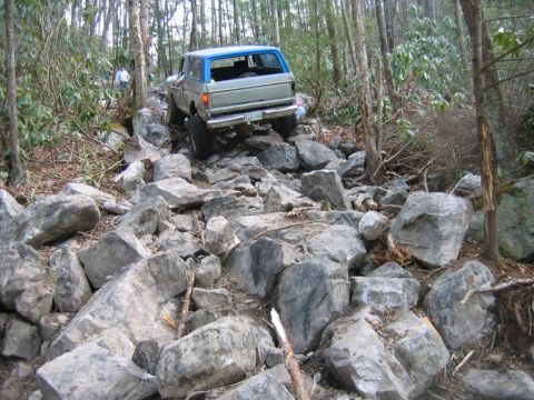 1992 Ford Mustang - A 1979 Ford F-Series truck navigates a challenging rocky trail, with another vehicle visible in the background.