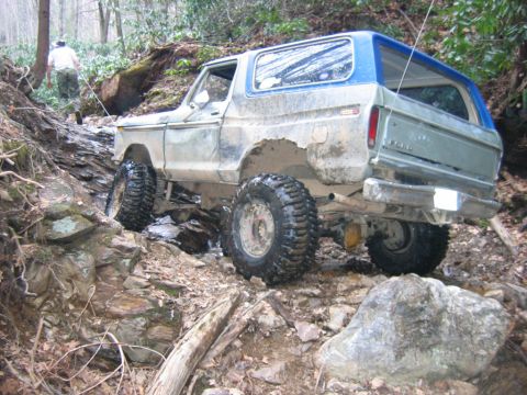 1992 Ford Mustang - This Ford Bronco navigates a challenging, rocky trail with large off-road tires.