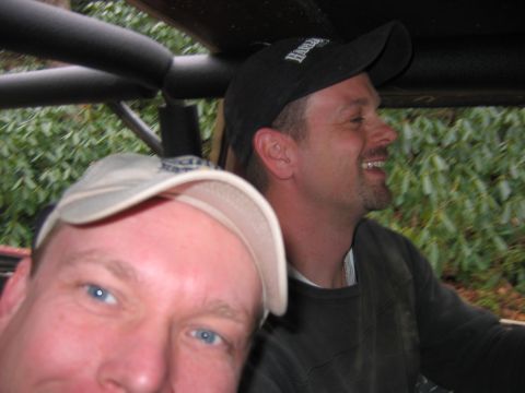 1992 Ford Mustang - Two men are inside a vehicle, with foliage visible in the background.