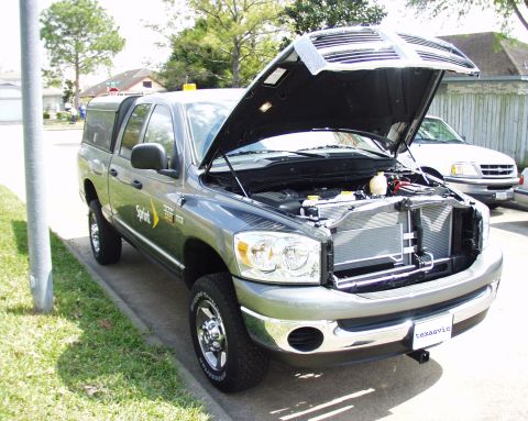 2000 Ford Crown Victoria - Gray Dodge Ram pickup truck with hood open, parked next to a white truck.