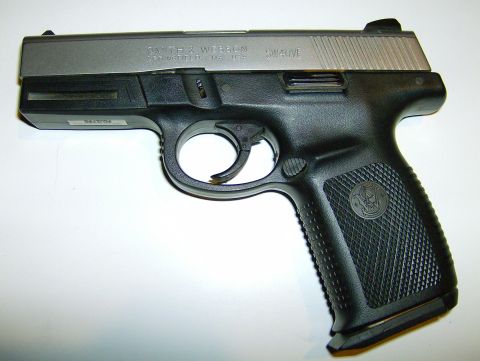 1982 Chevrolet C/K Pickup - Smith & Wesson SW40VE pistol shown against a white background.