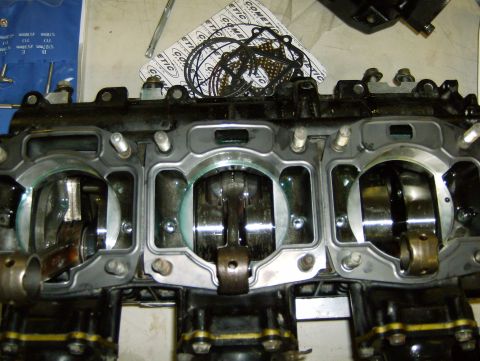 1982 Chevrolet C/K Pickup - Engine block disassembled, showing pistons and crankshaft components. Gasket set is also visible.