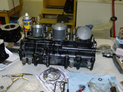 1982 Chevrolet C/K Pickup - Engine block and pistons are laid out on a workbench with various tools and gasket parts.