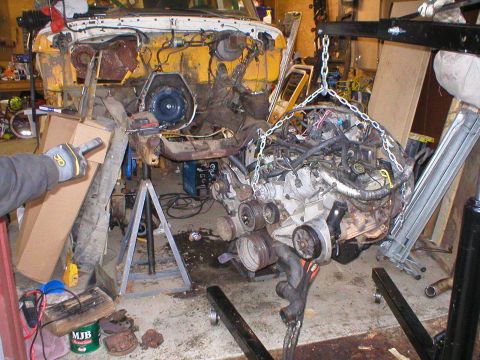 1978 Ford Bronco - Engine removal in progress, with the vehicle chassis partially visible and supported by stands.