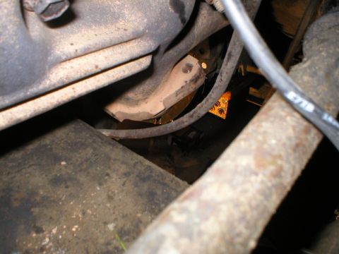 1978 Ford Bronco - Close-up view of engine bay components shows an oil leak and signs of rust.